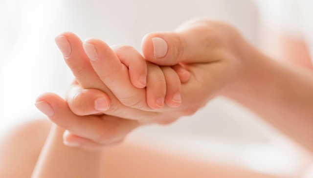 close-up-mom-holding-baby-s-hand